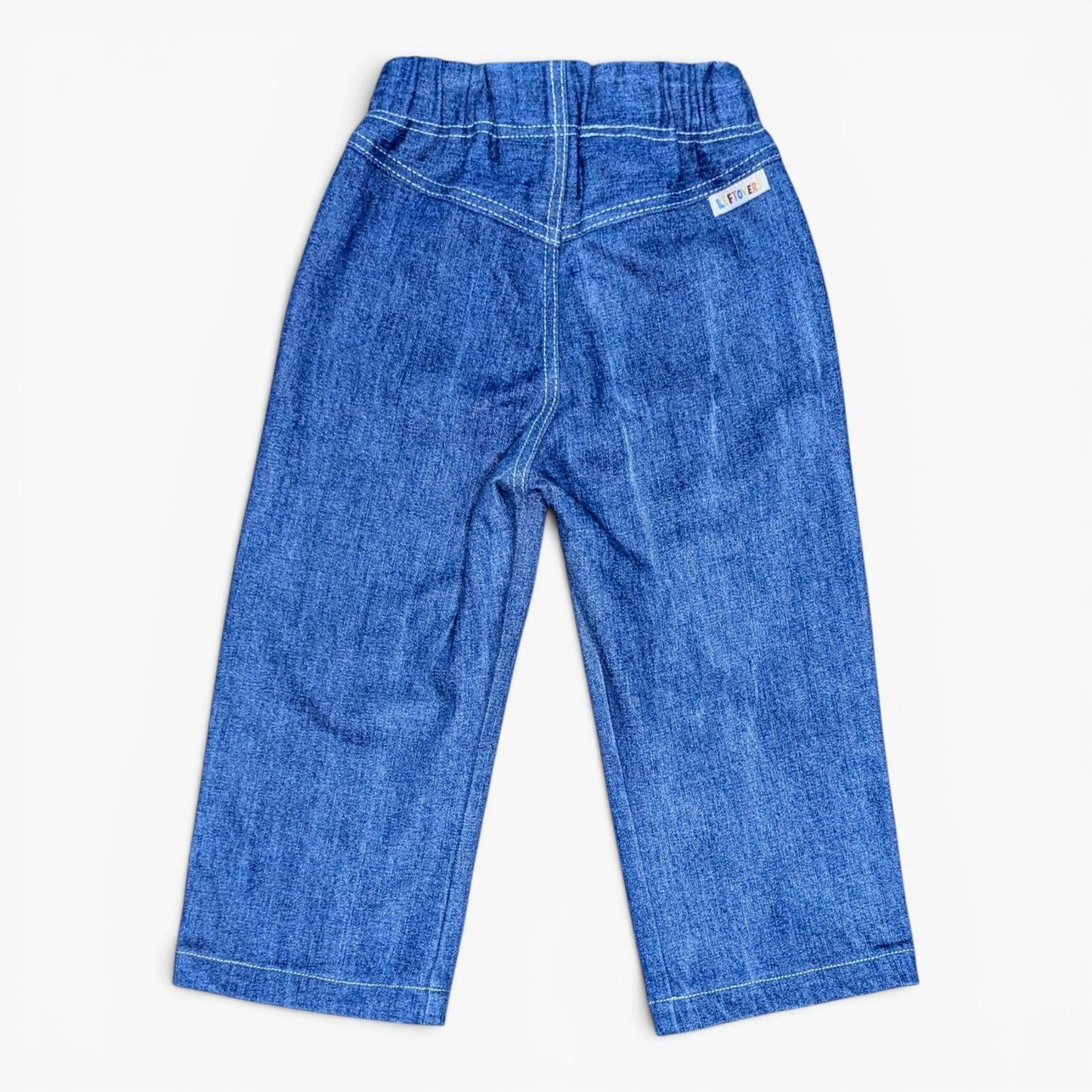 A pair of Leftovers Club Sammy Sailor blue denim jeans for kids, featuring an elastic waistband, front pockets, and contrast