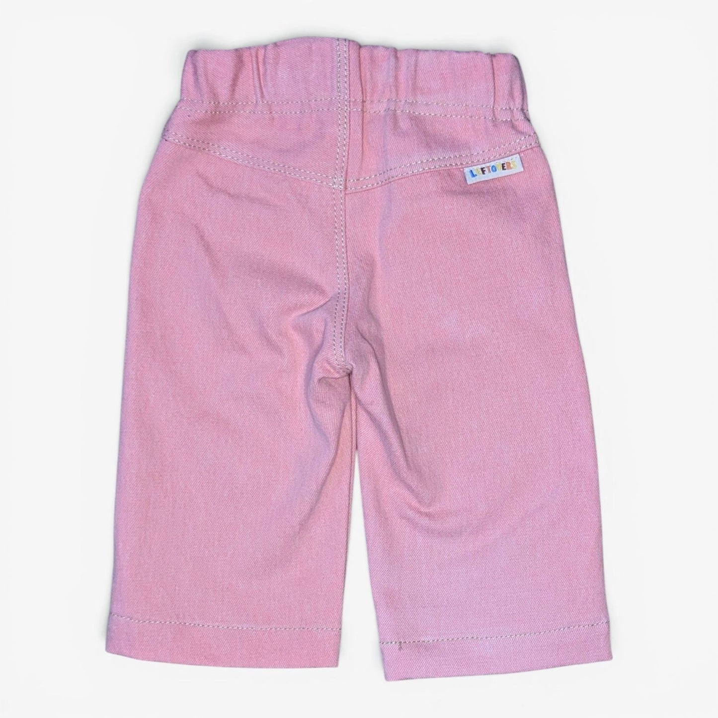 A pair of Leftovers Club Sammy Sailor pink denim jeans for kids, featuring an elastic waistband, front pockets, and contrast