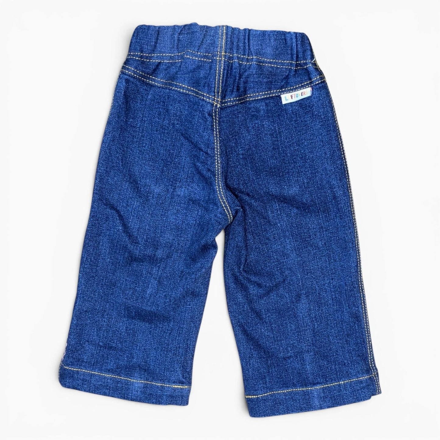 A pair of Leftovers Club Sammy Sailor blue denim jeans for kids, featuring an elastic waistband, front pockets, and contrast