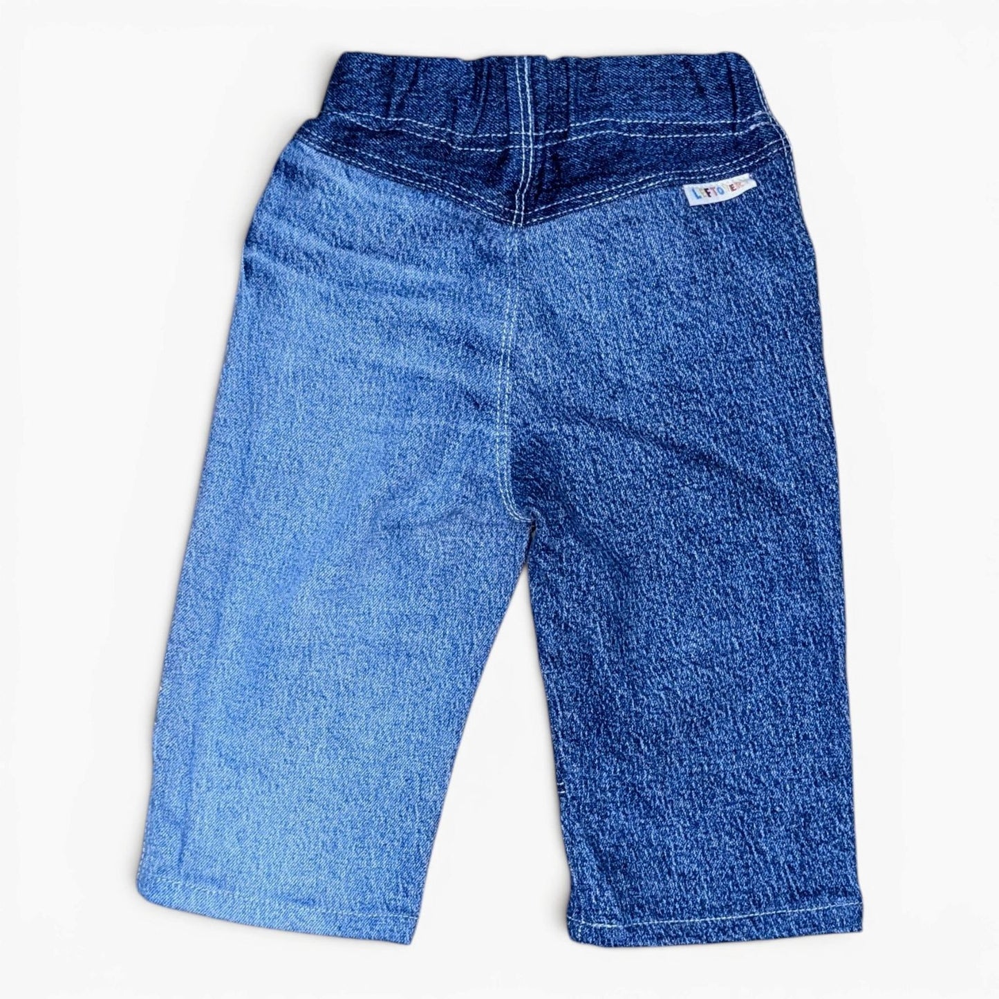 A pair of Leftovers Club Stevie Straight blue denim jeans for kids, featuring horizontal knee panels, an elastic waistband, f
