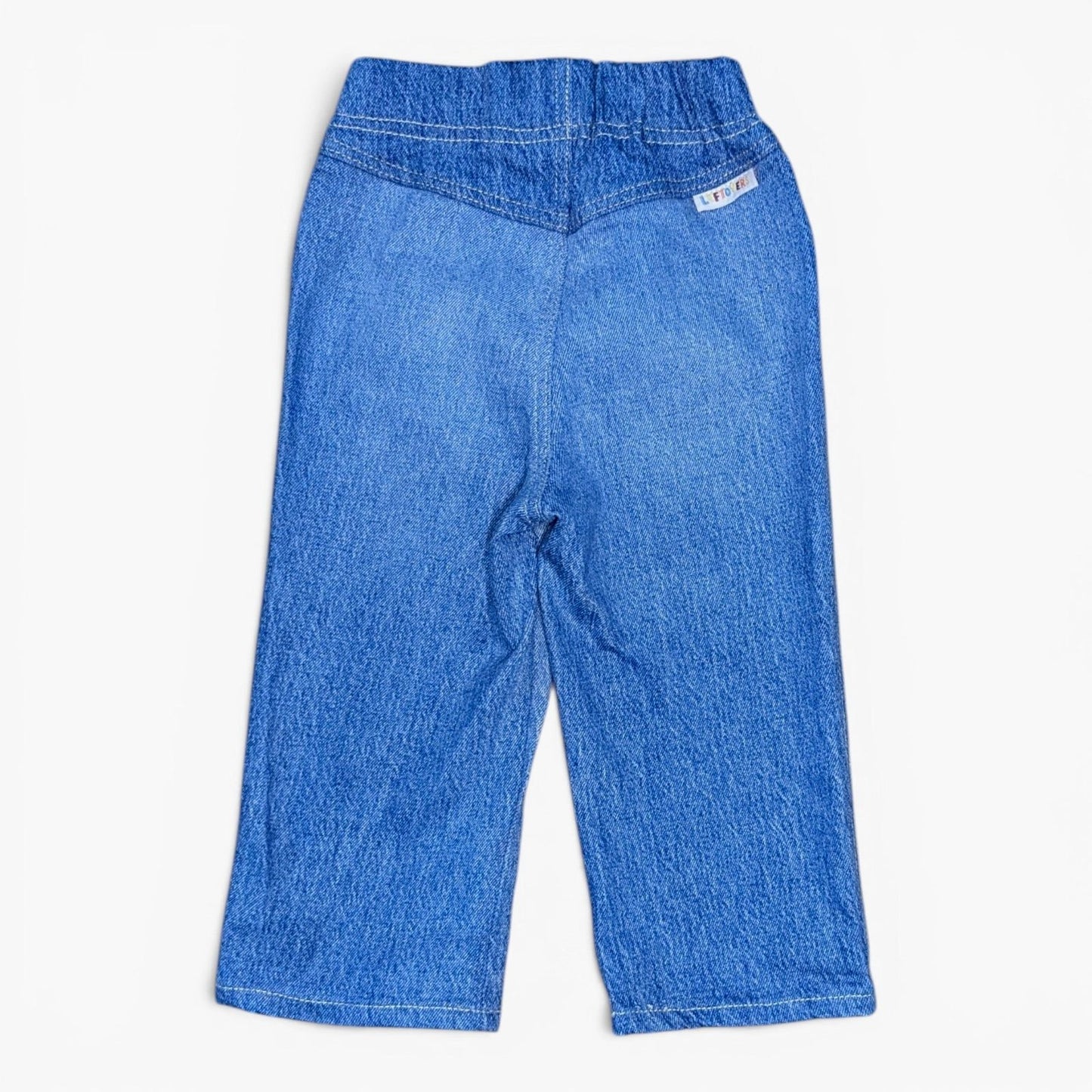 A pair of Leftovers Club Stevie Straight blue denim jeans for kids, featuring an elastic waistband, front pockets, and contra