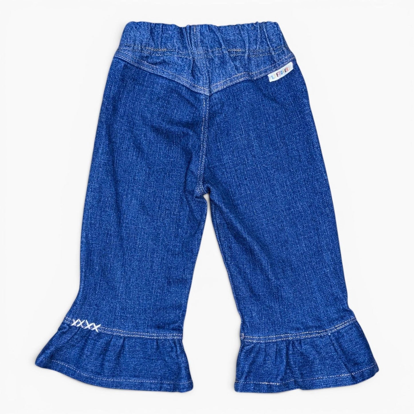 A pair of Leftovers Club Frankie Flare blue denim jeans for kids, featuring an elastic waistband, front pockets, and contrast