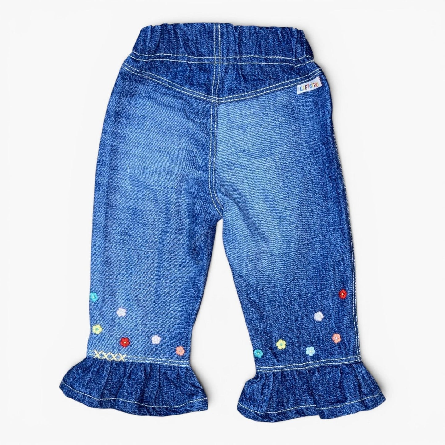 A pair of Leftovers Club Frankie Flare blue denim jeans for kids, featuring an elastic waistband, front pockets, and contrast