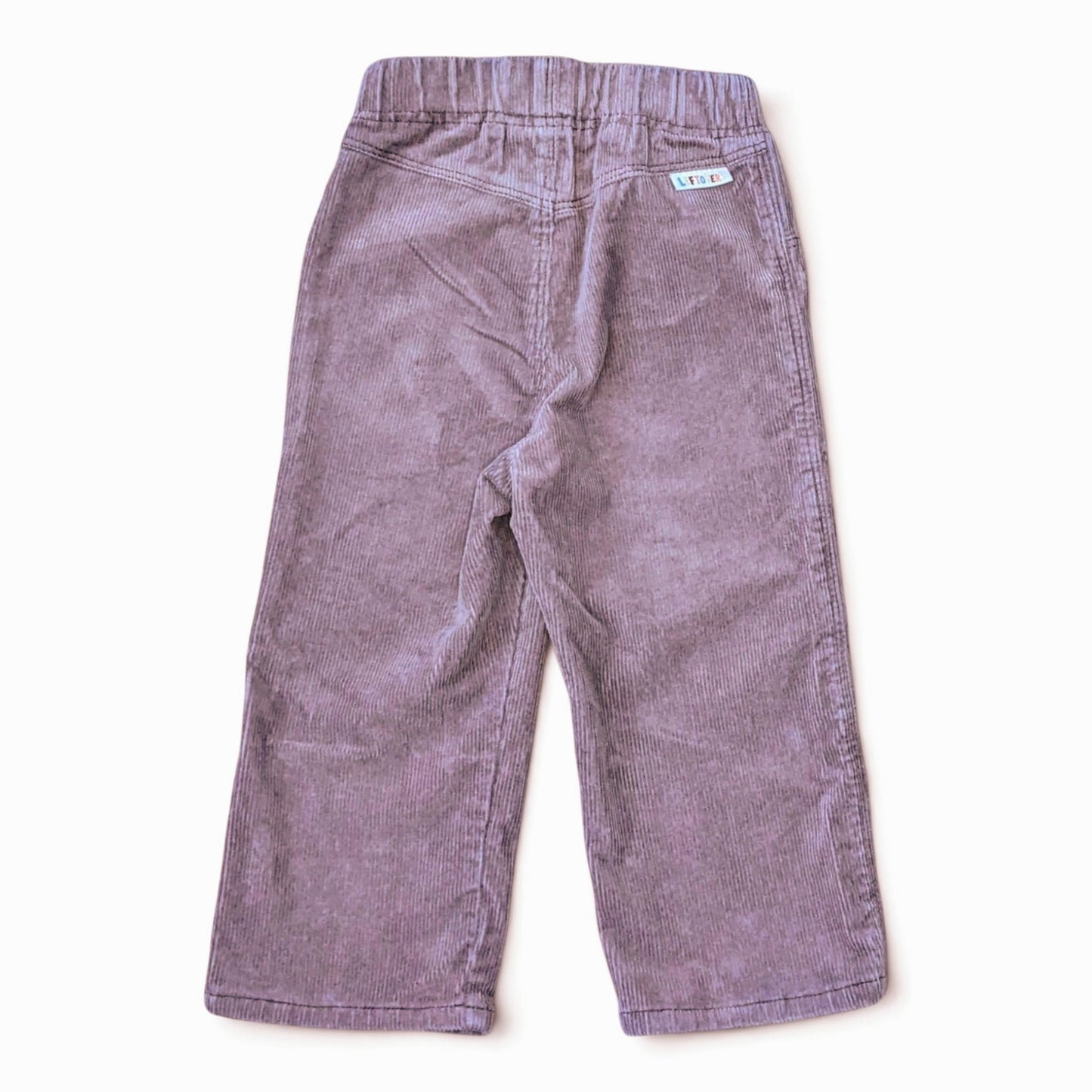 Leftovers club brown cord jeans for toddlers. Stevie straight style featuring an elastic waistband. Back view on white backgr