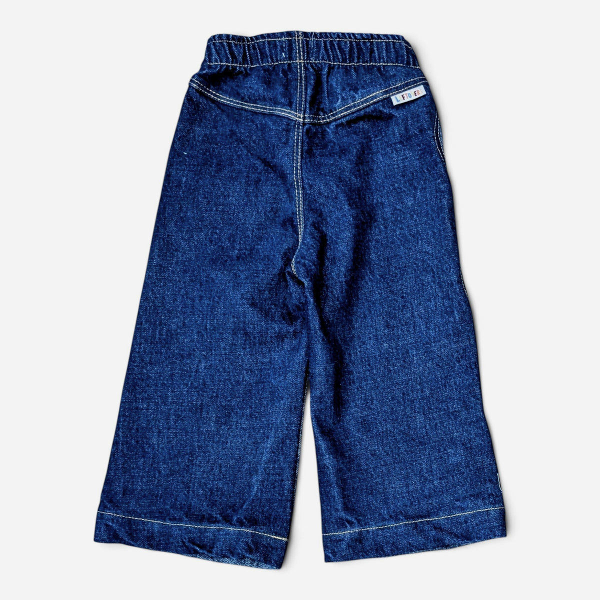 Leftovers Club Winnie Wide and Wavy Jean in a mixed dark and mid blue wash with wavy side seams and wide hem.