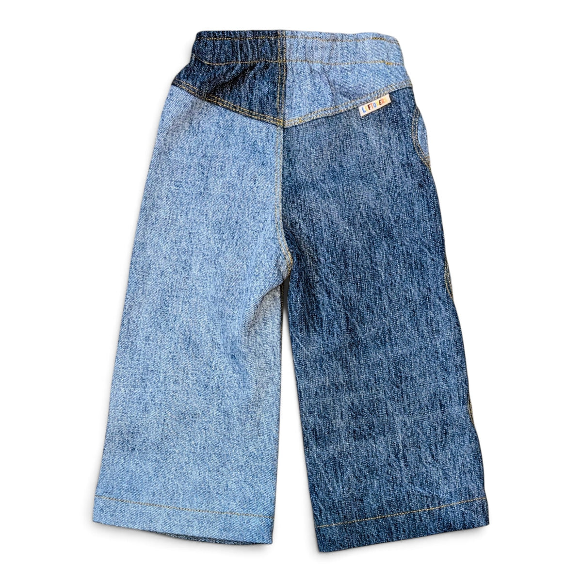 Leftovers Club Winnie Wide and Wavy Jean in a mixed light and mid blue wash with wavy side seams and wide hem.