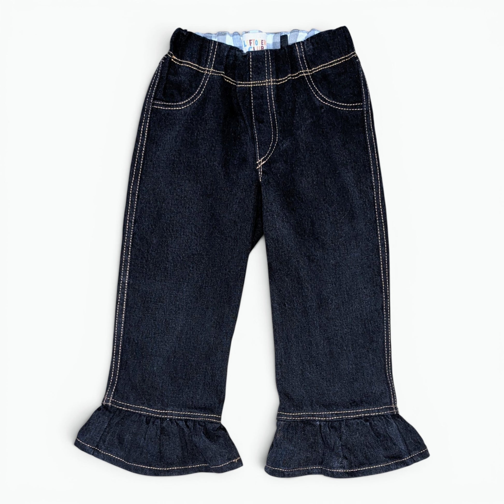 Dark wash denim cropped pants with a ruffled hem and contrast light stitching, shown flat on a white background.
