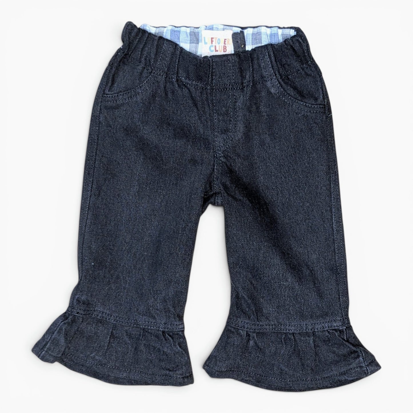 A pair of dark blue denim cropped pants with a ruffled hem and a light blue and white striped inner waistband, shown flat on a white background.