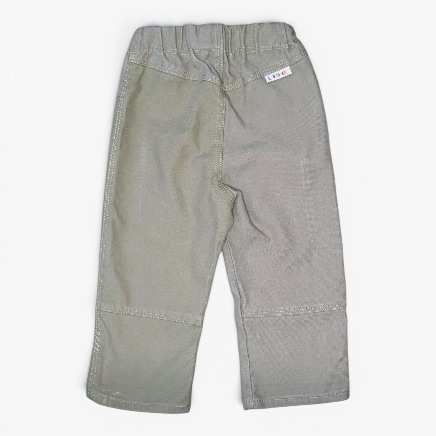 A pair of light gray toddler pants shown from the back, featuring an elastic waistband, side pockets, and reinforced seam patches on the legs, laid flat against a white background.