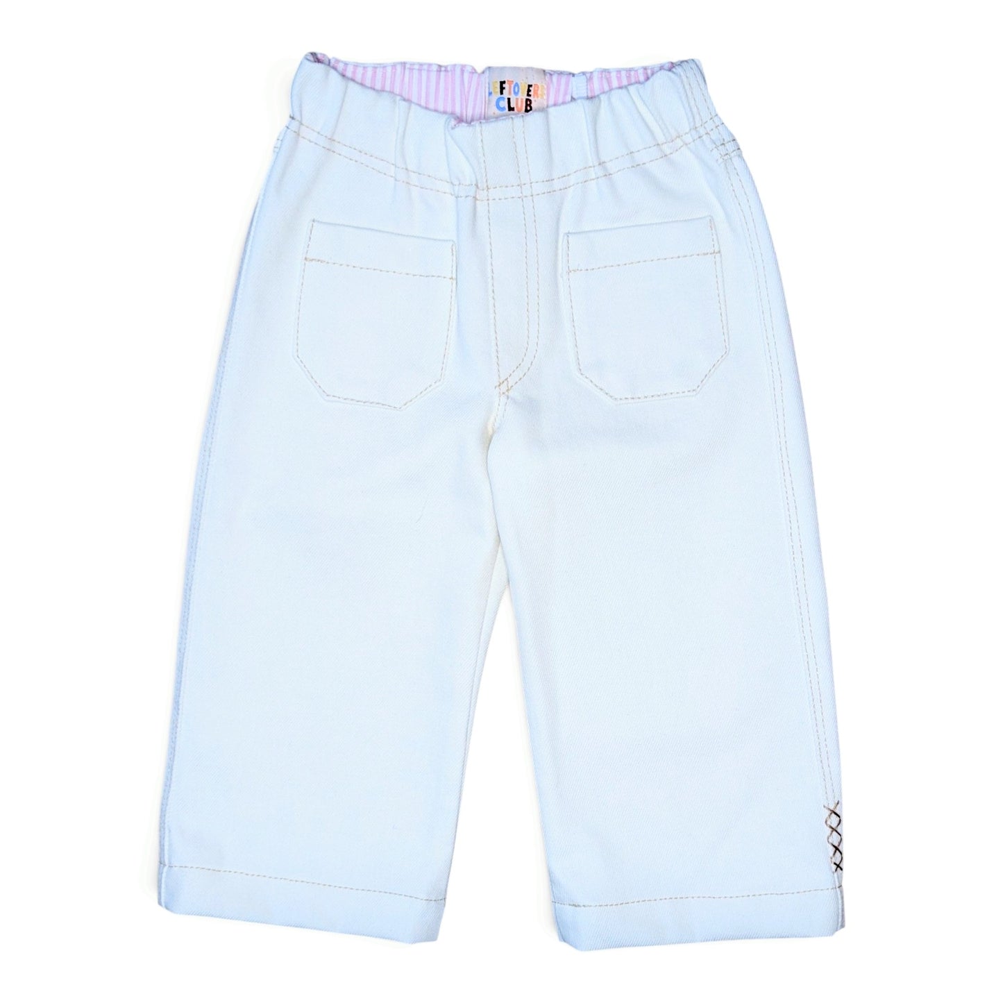 A pair of white denim pants for kids, shown from the back. The pants feature an elastic waistband with a pink and white striped inner lining, two large patch pockets, and contrast stitching.