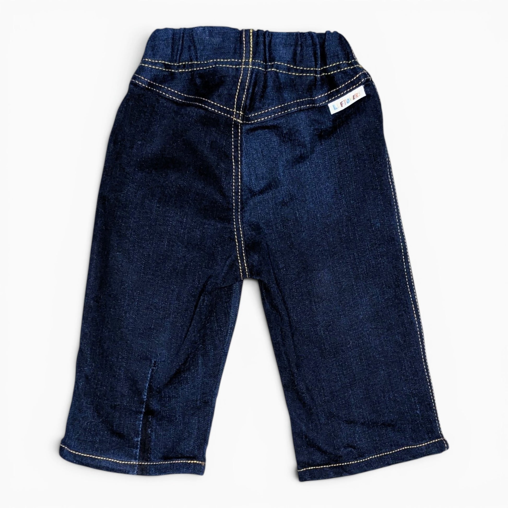 A pair of dark blue denim toddler pants with contrast light-colored stitching and an elastic waistband, shown flat on a white background.