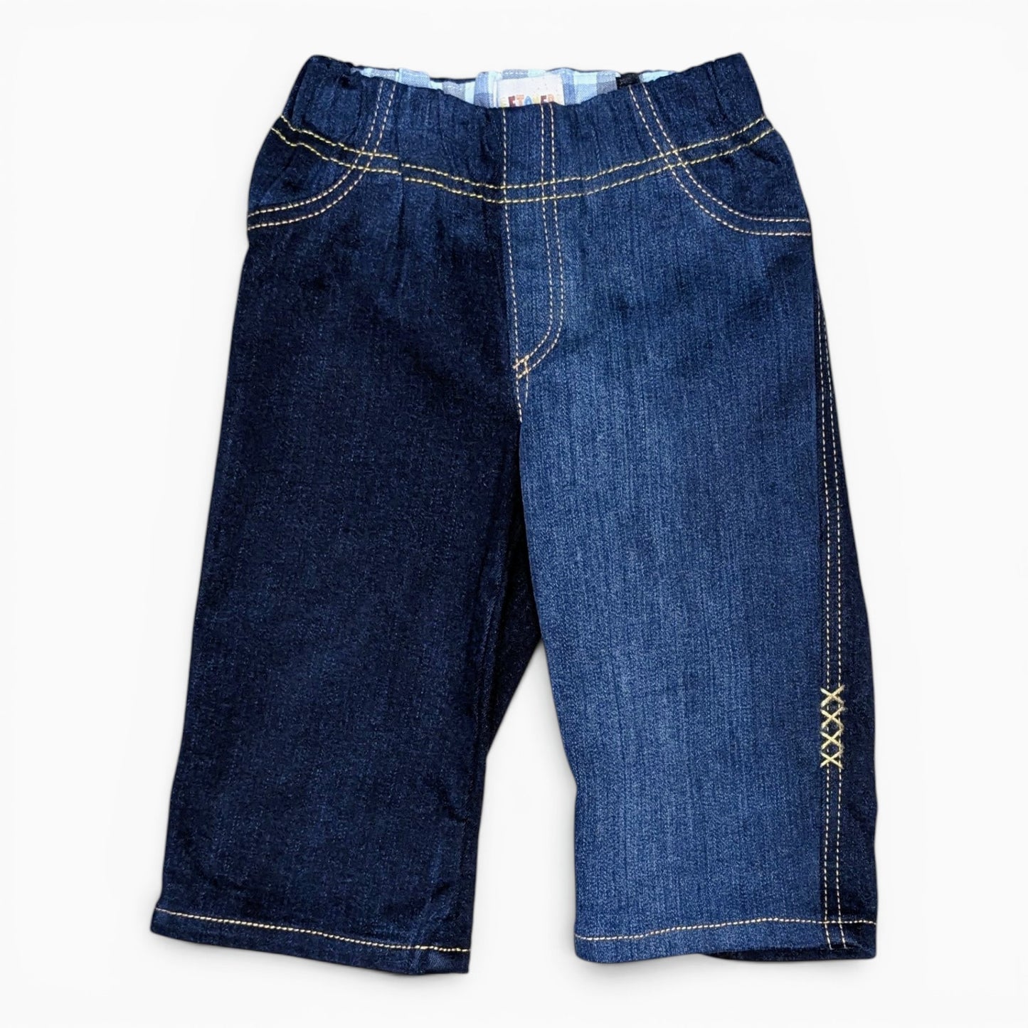 A pair of dark blue denim pantswith contrasting light beige stitching, displayed flat against a plain white background.