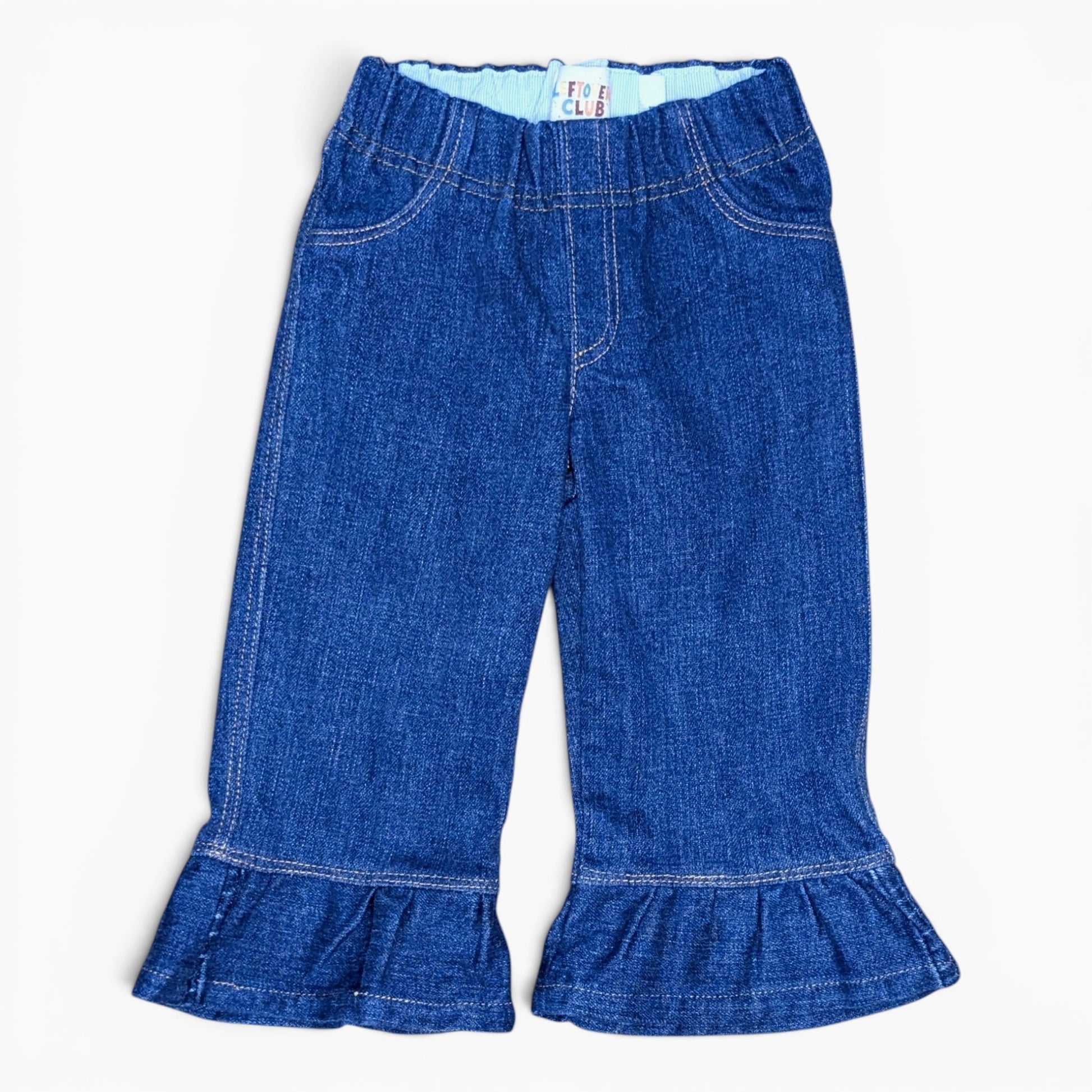 A pair of toddler blue denim flare pants with a ruffled hem, shown flat against a white background.
