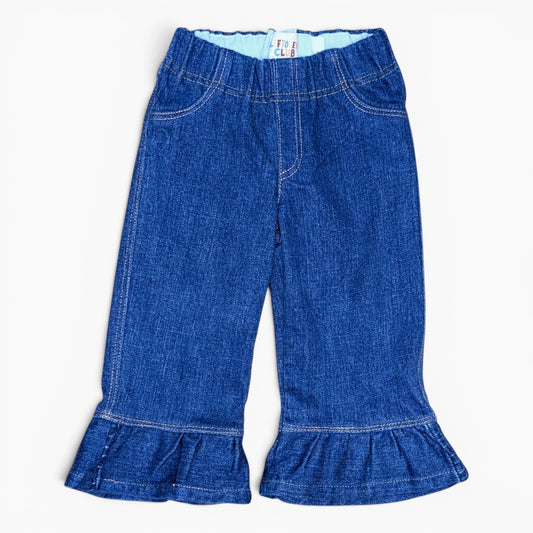 A pair of toddler blue denim flare pants with a ruffled hem, shown flat against a white background.