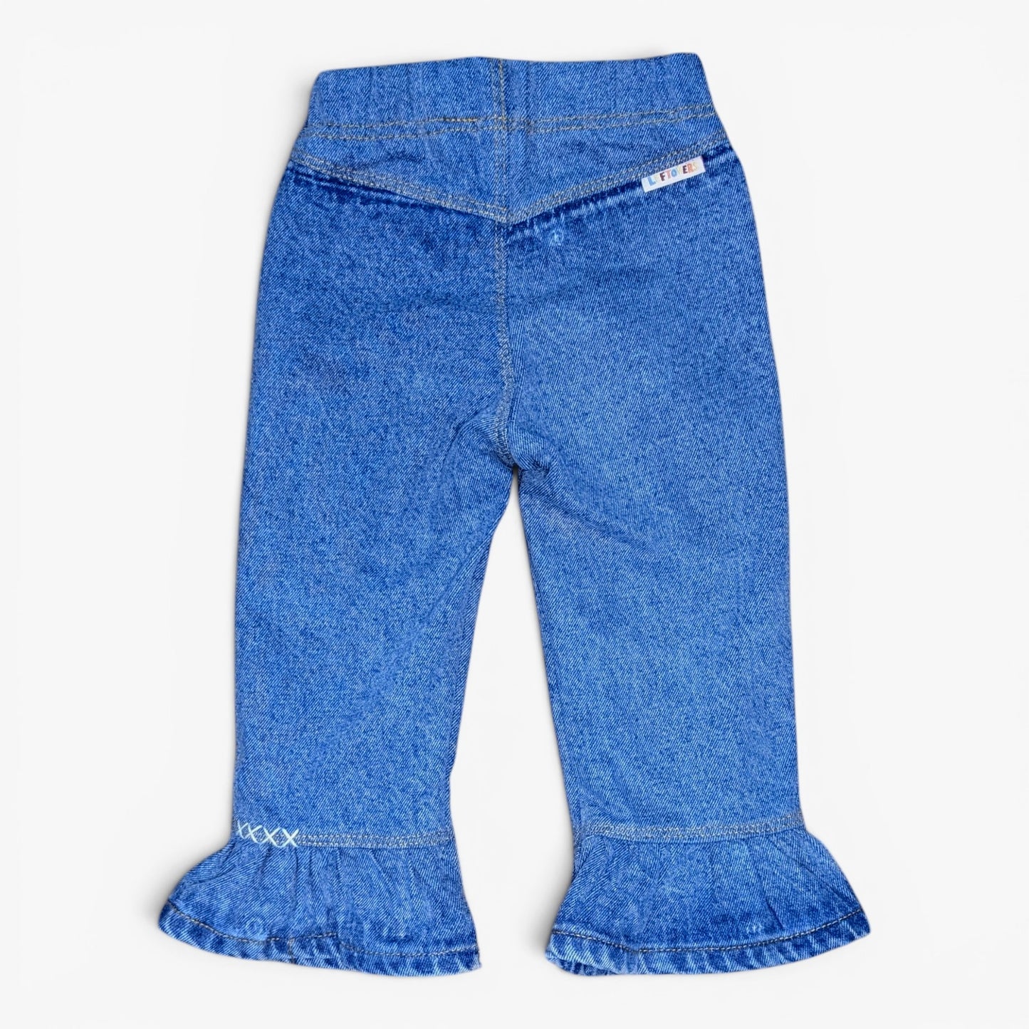 Blue denim cropped pants with a high waist and flared ruffled cuffs, shown flat against a light gray background.