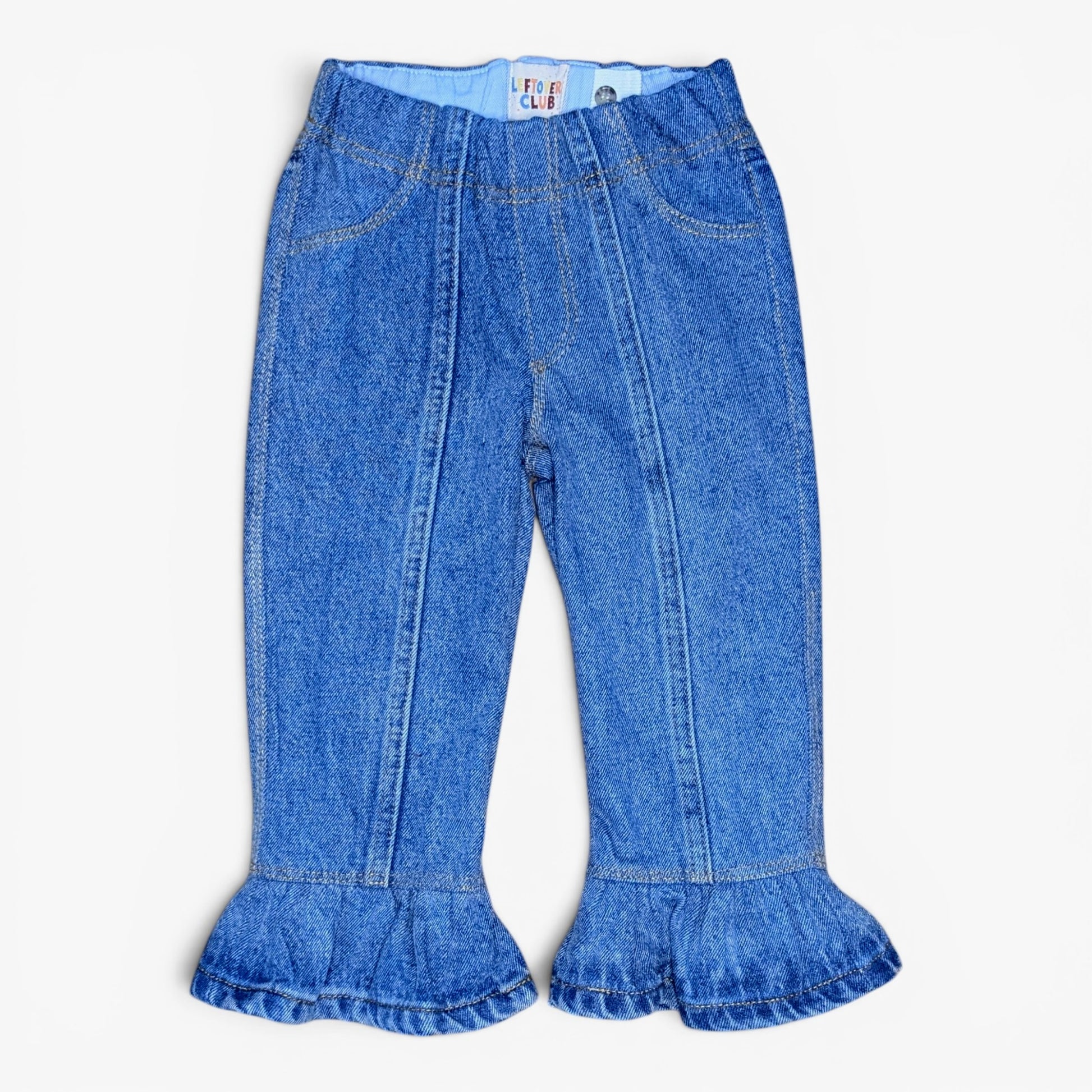 A pair of toddler blue denim flare pants with ruffled hems, shown flat against a light off-white background.