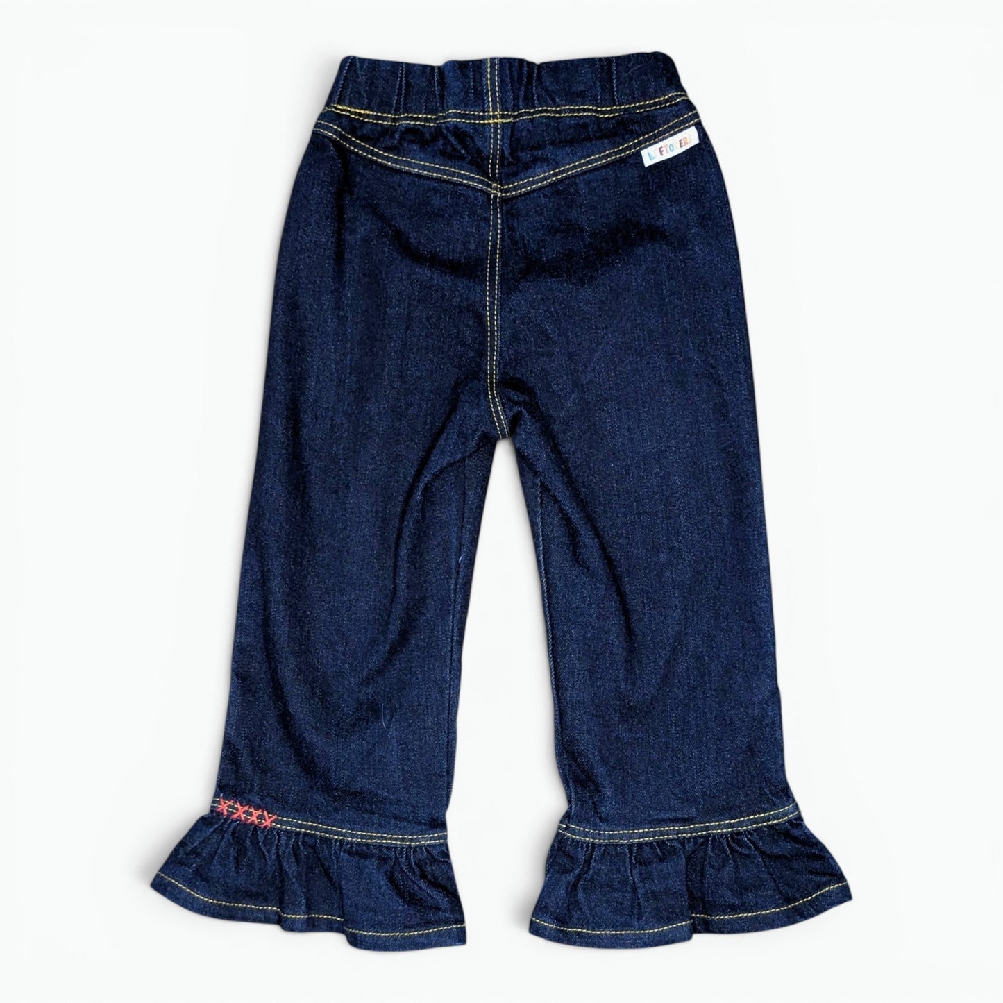 A pair of toddler denim flare pants with ruffled hems, shown flat on a white background. A small white label near the waistband and embroidered on the left ruffle.