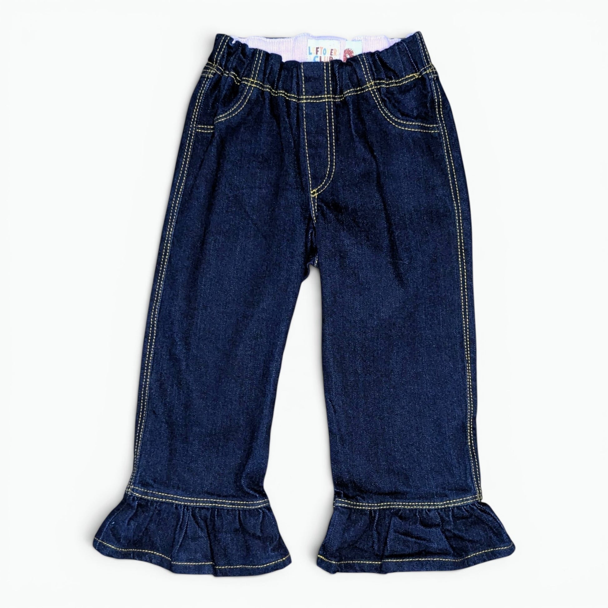 dark indigo jeans for toddlers with a frill flared hem laid flat on a white background