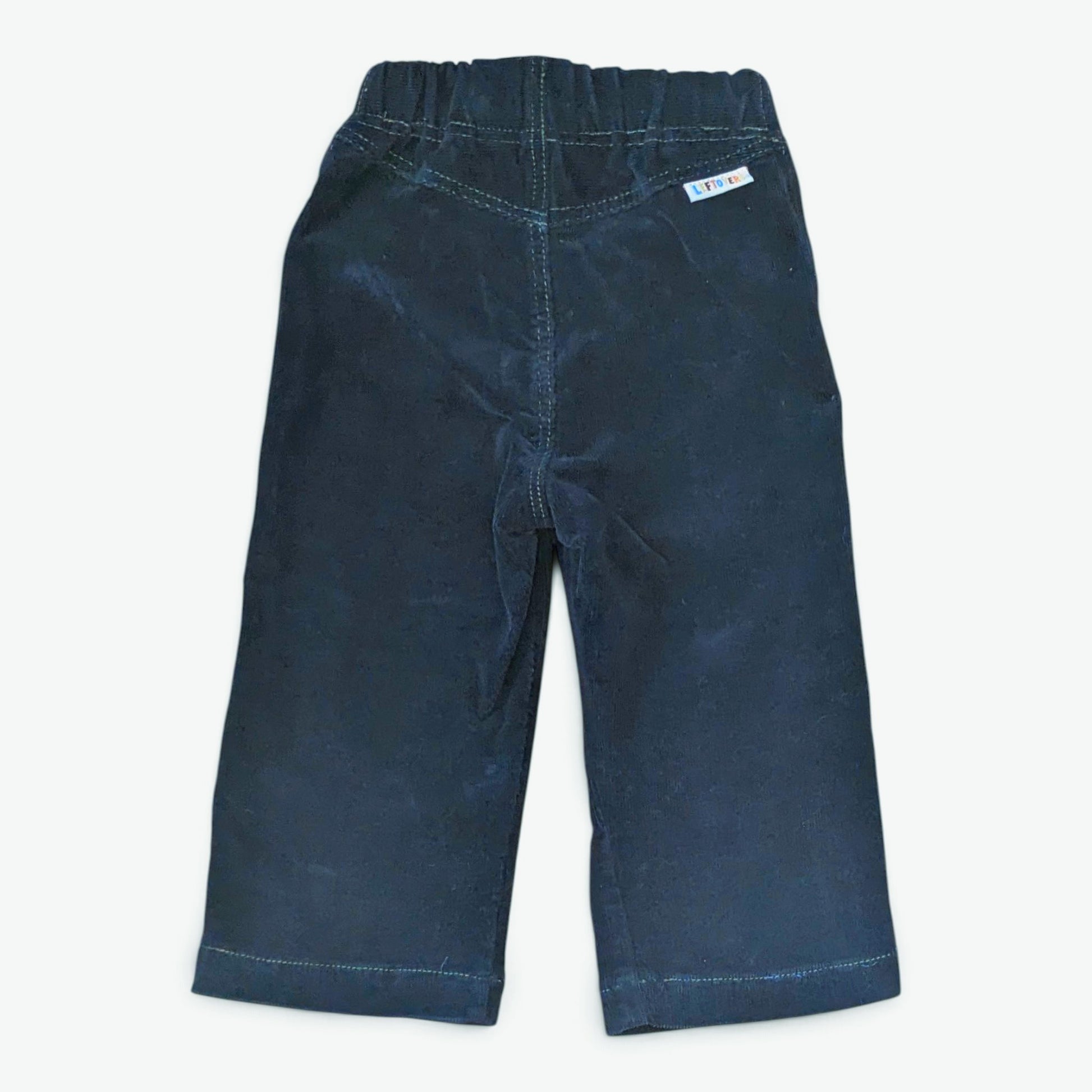Leftovers club dark blue cord jeans for toddlers. Stevie straight style featuring an elastic waistband. Back view on white ba
