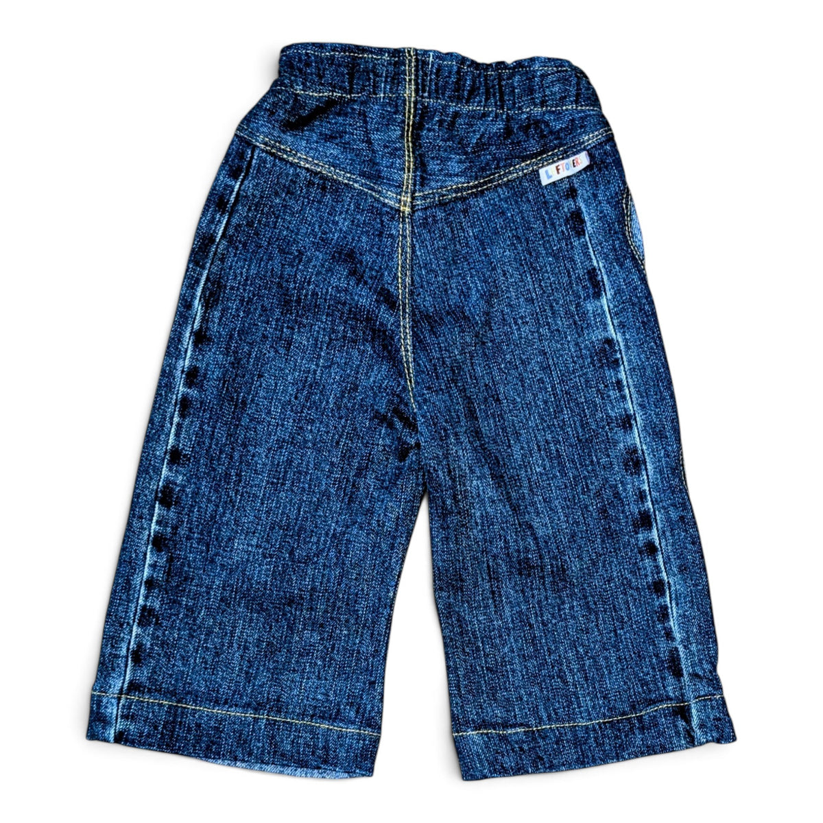 Leftovers Club Winnie Wide and Wavy Jean in a mixed dark and mid blue wash with wavy side seams and wide hem. 