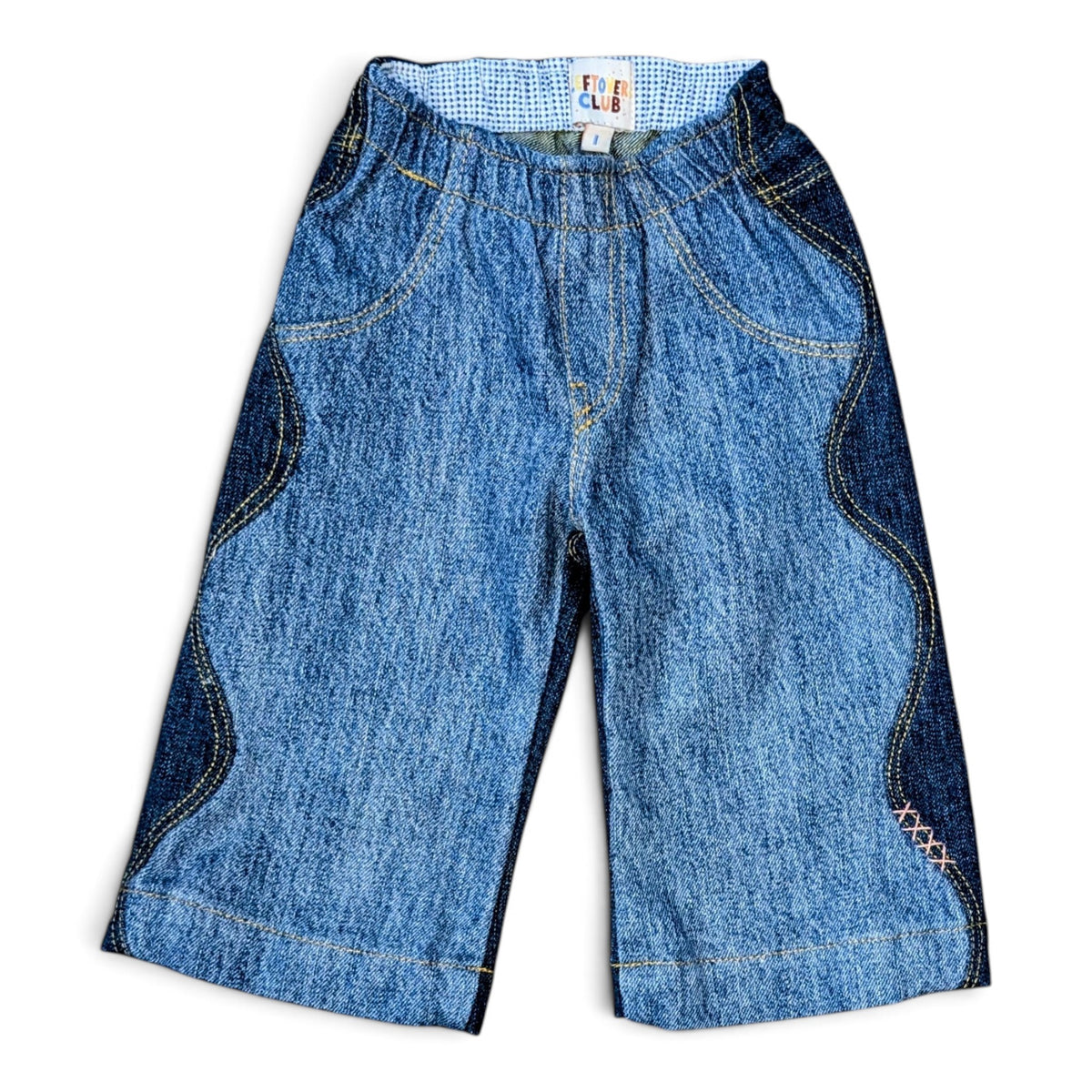 Leftovers Club Winnie Wide and Wavy Jean in a mixed dark and mid blue wash with wavy side seams and wide hem. 