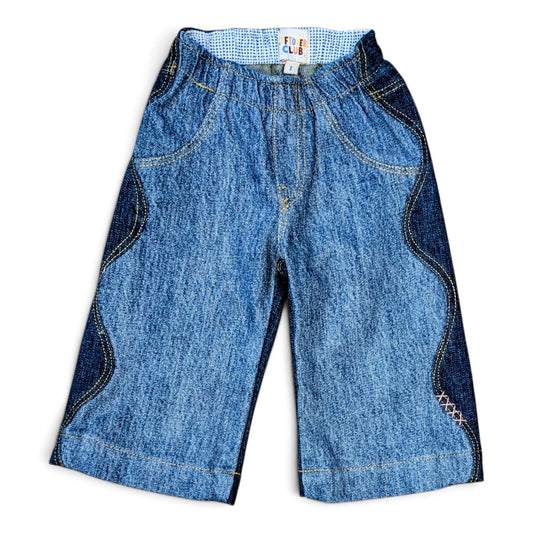 Leftovers Club Winnie Wide and Wavy Jean in a mixed dark and mid blue wash with wavy side seams and wide hem. 