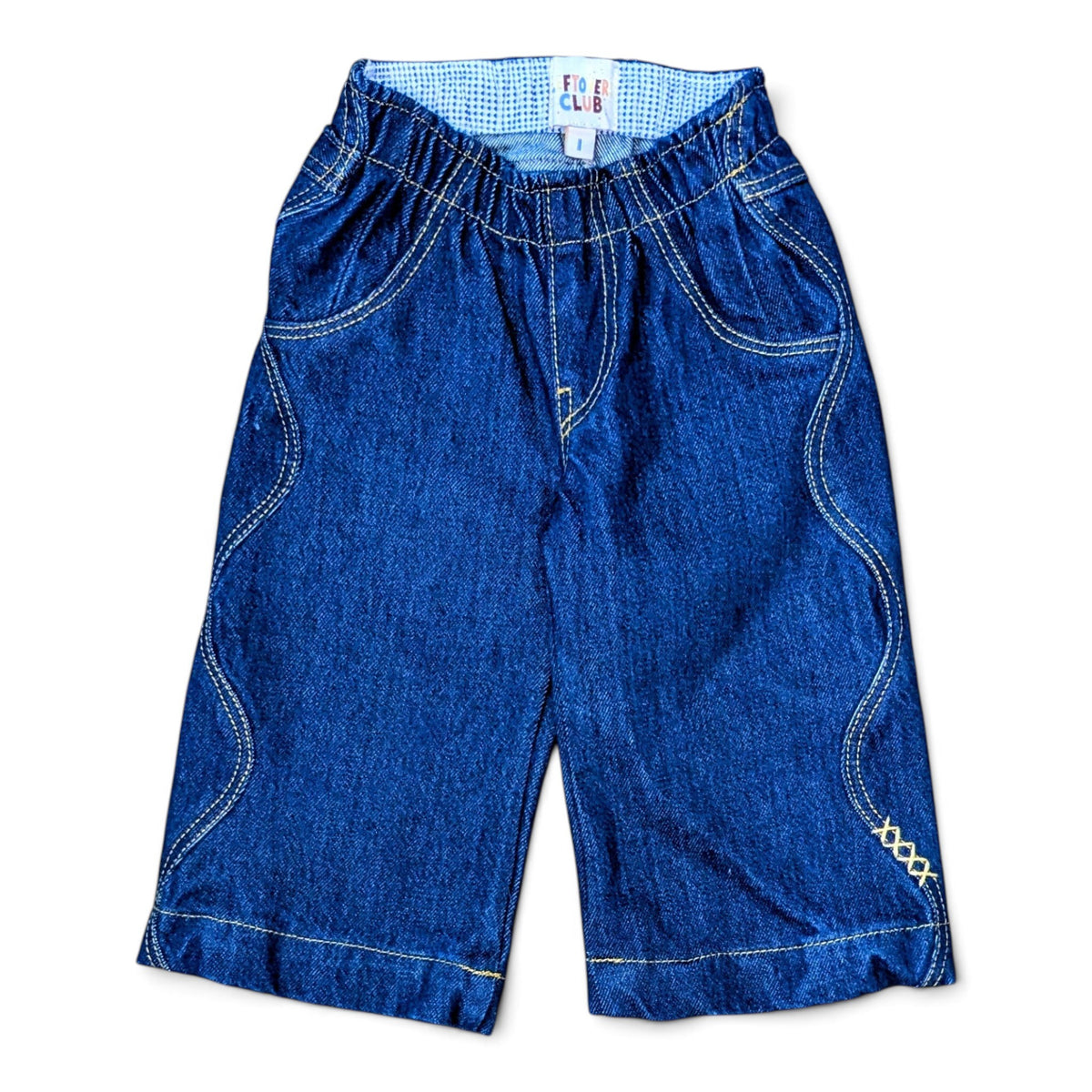 Leftovers Club Winnie Wide and Wavy Jean in a dark mid blue wash with wavy side seams and wide hem. 