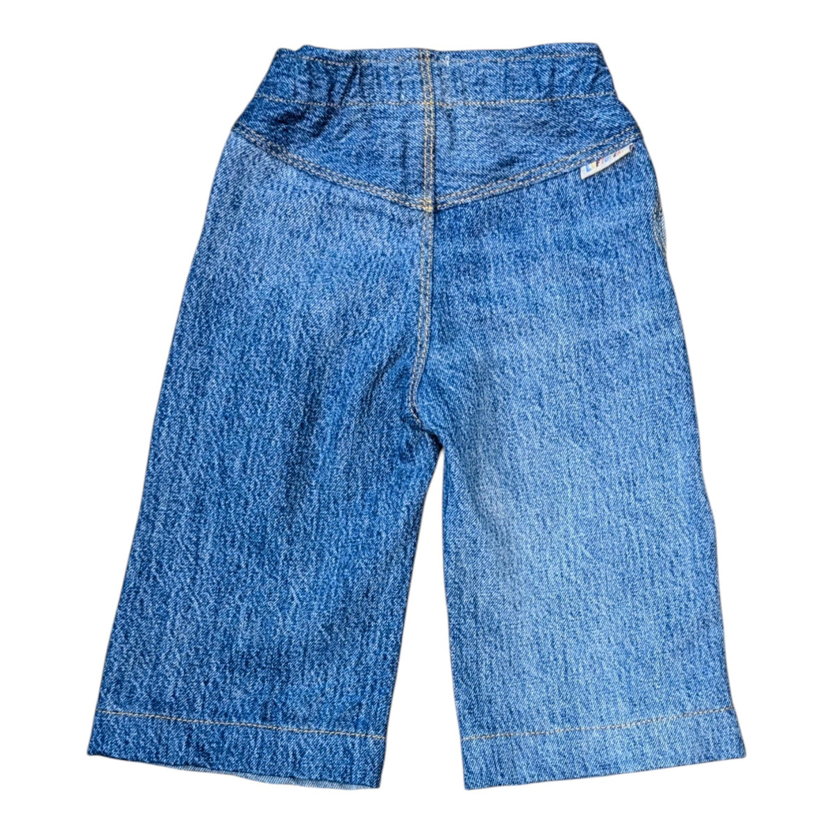 Leftovers Club Winnie Wide and Wavy Jean in a mixed light and mid blue wash with wavy side seams and wide hem. 