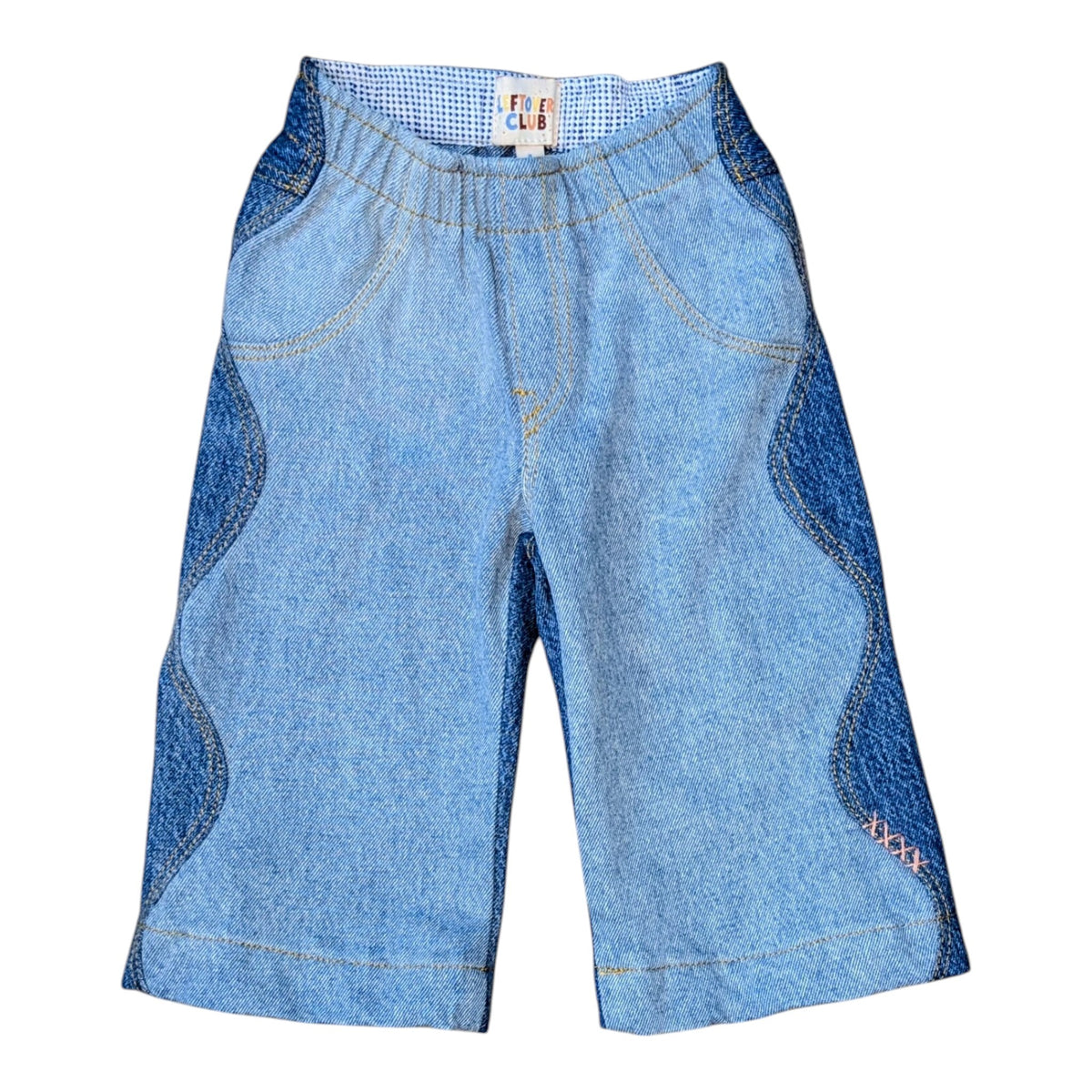 Leftovers Club Winnie Wide and Wavy Jean in a mixed light and mid blue wash with wavy side seams and wide hem. 