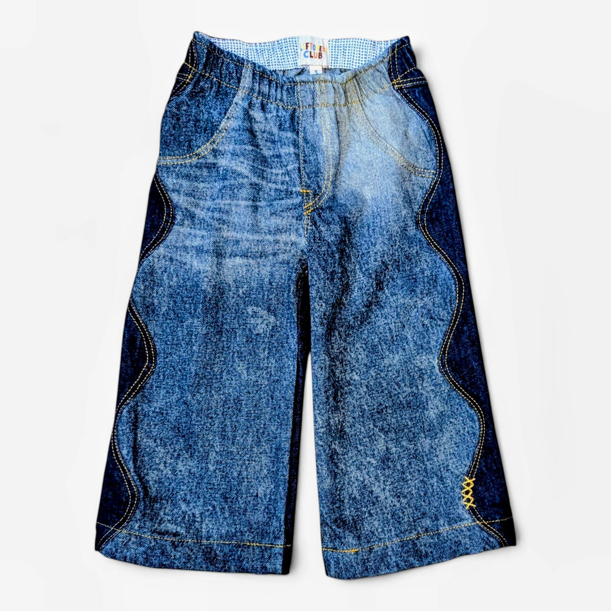 Leftovers Club Winnie Wide and Wavy Jean in a mixed dark and mid blue wash with wavy side seams and wide hem. 
