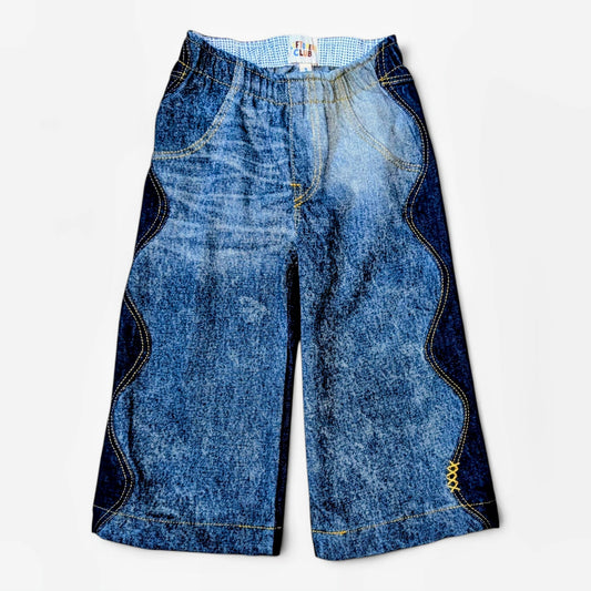 Leftovers Club Winnie Wide and Wavy Jean in a mixed dark and mid blue wash with wavy side seams and wide hem. 