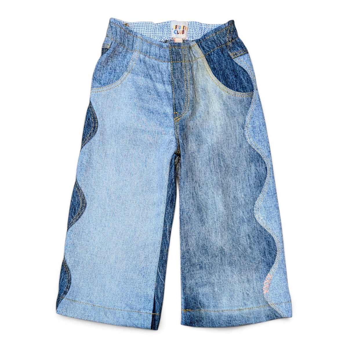 Leftovers Club Winnie Wide and Wavy Jean in a mixed light and mid blue wash with wavy side seams and wide hem. 